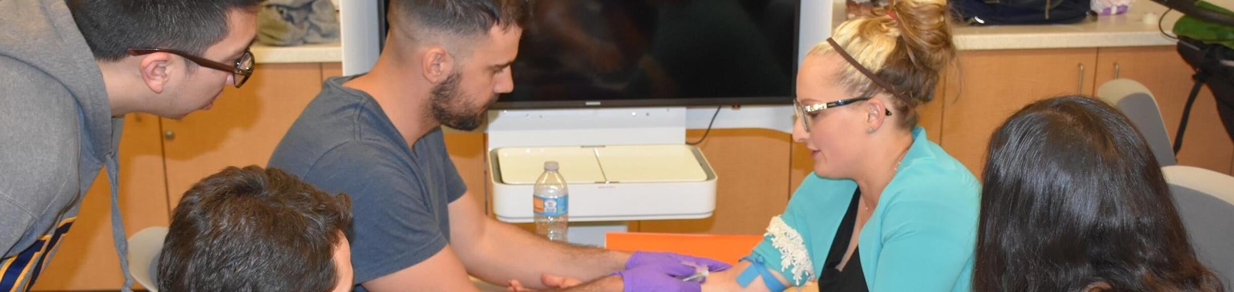 student drawing blood